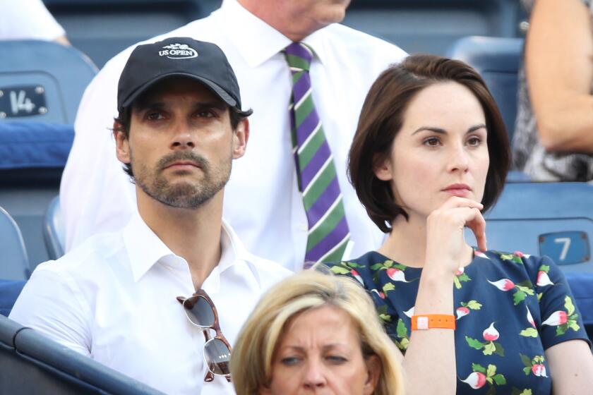 Michelle Dockery and John Dineen watch a tennis match in September 2013.