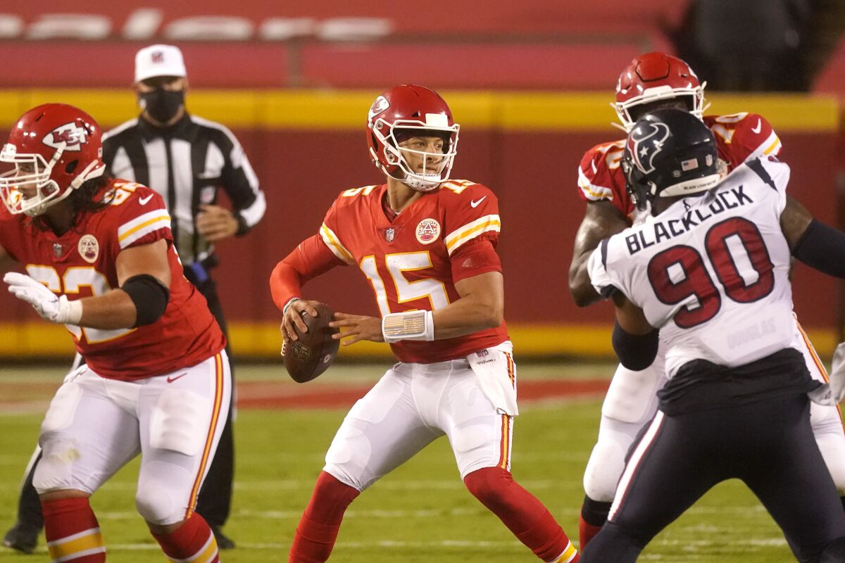 Kansas City Chiefs quarterback Patrick Mahomes (15) passes against the Houston Texans in the first half of an NFL football game Thursday, Sept. 10, 2020, in Kansas City, Mo. (AP Photo/Charlie Riedel)