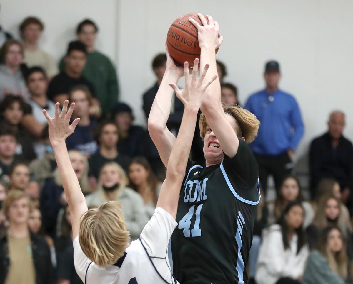 Corona del Mar's George Bruening stops and turns to sink a basket during the Battle of the Bay boys' basketball game.