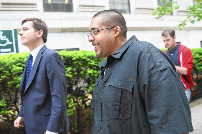 Hector Xavier Monsegur, right, walks out of federal court in New York after he was sentenced to time served.