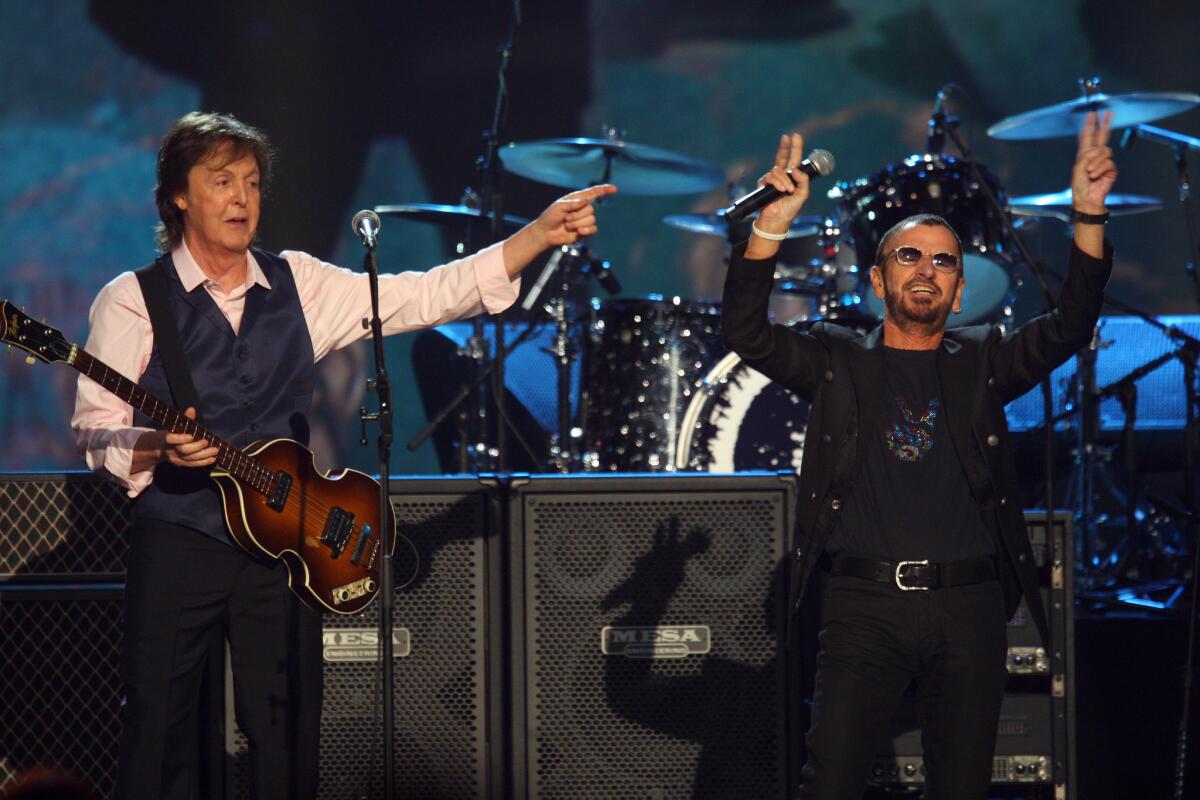 Paul McCartney and Ringo Starr, shown performing last year, will appear together again for the 2015 Rock and Roll Hall of Fame induction ceremony in Cleveland. Starr is being inducted as a solo act.