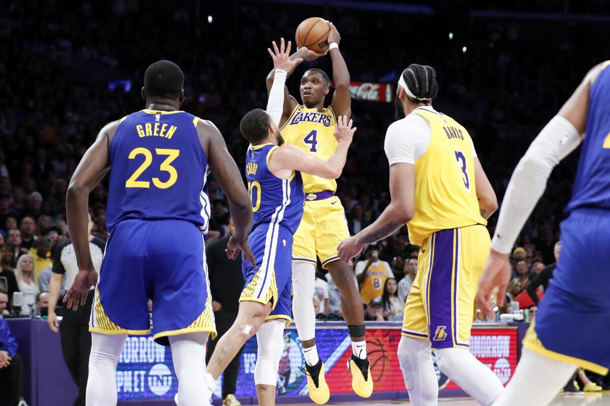 Lakers guard Lonnie Walker IV elevates for a jumper over Warriors guard Stephen Curry during Game 4 on Monday night.
