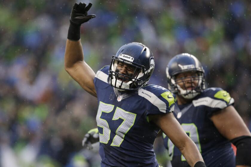 Seattle Seahawks linebacker Mike Morgan celebrates an unsuccessful field-goal attempt by the New Orleans Saints in the NFC divisional playoffs. Morgan, an ex-Trojan, is one of several players competing in the Super Bowl with USC and UCLA connections.