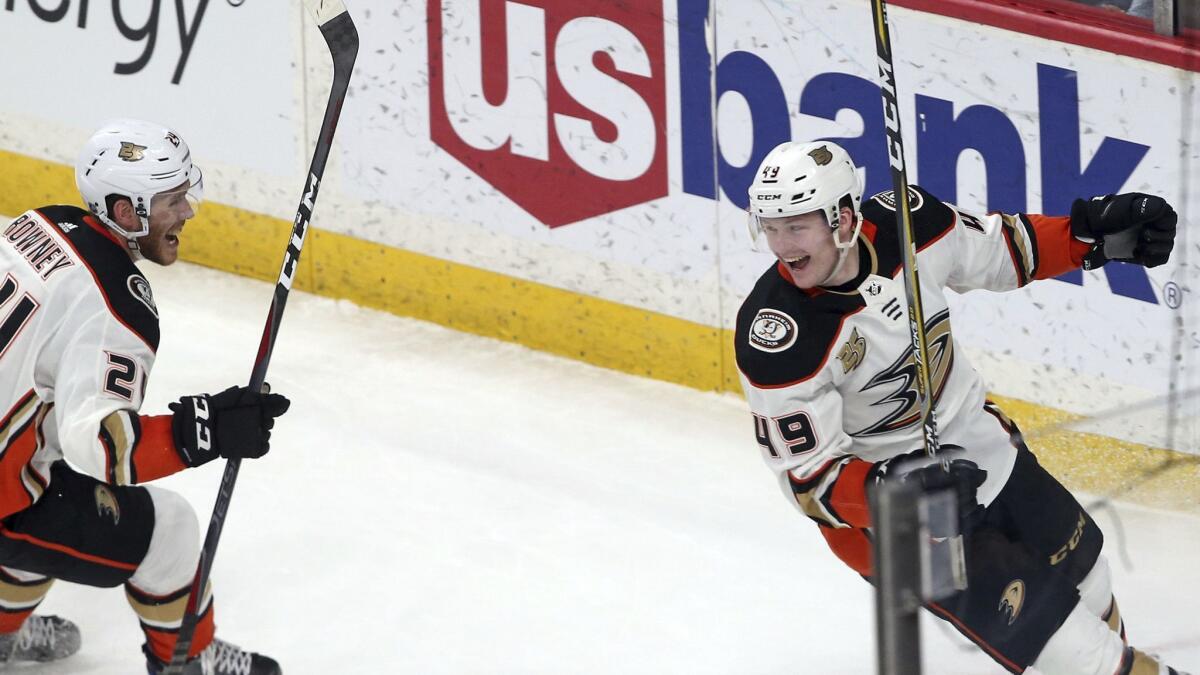 Ducks' Carter Rowney, left, and Max Jones celebrate a goal by Ryan Kesler in the third period on Feb.19, 2019, in St. Paul, Minn.