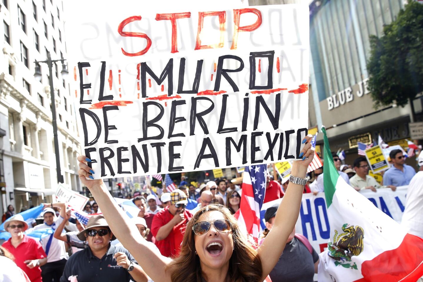 People rally for immigration reform on Broadway during May Day protests downtown Los Angeles.