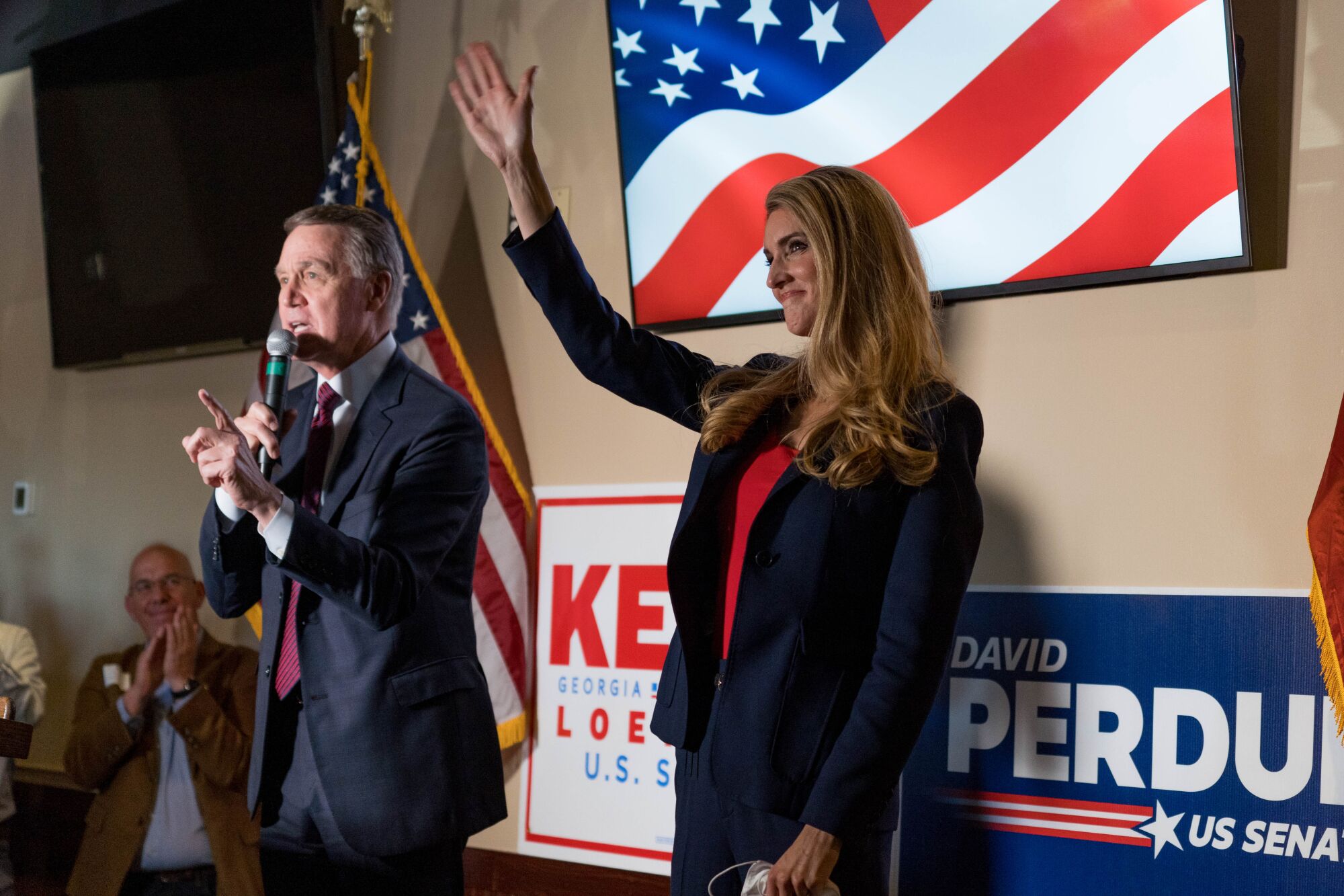 Republican Sens. David Perdue and Kelly Loeffler speak at a Nov. 13 campaign event in Cumming.