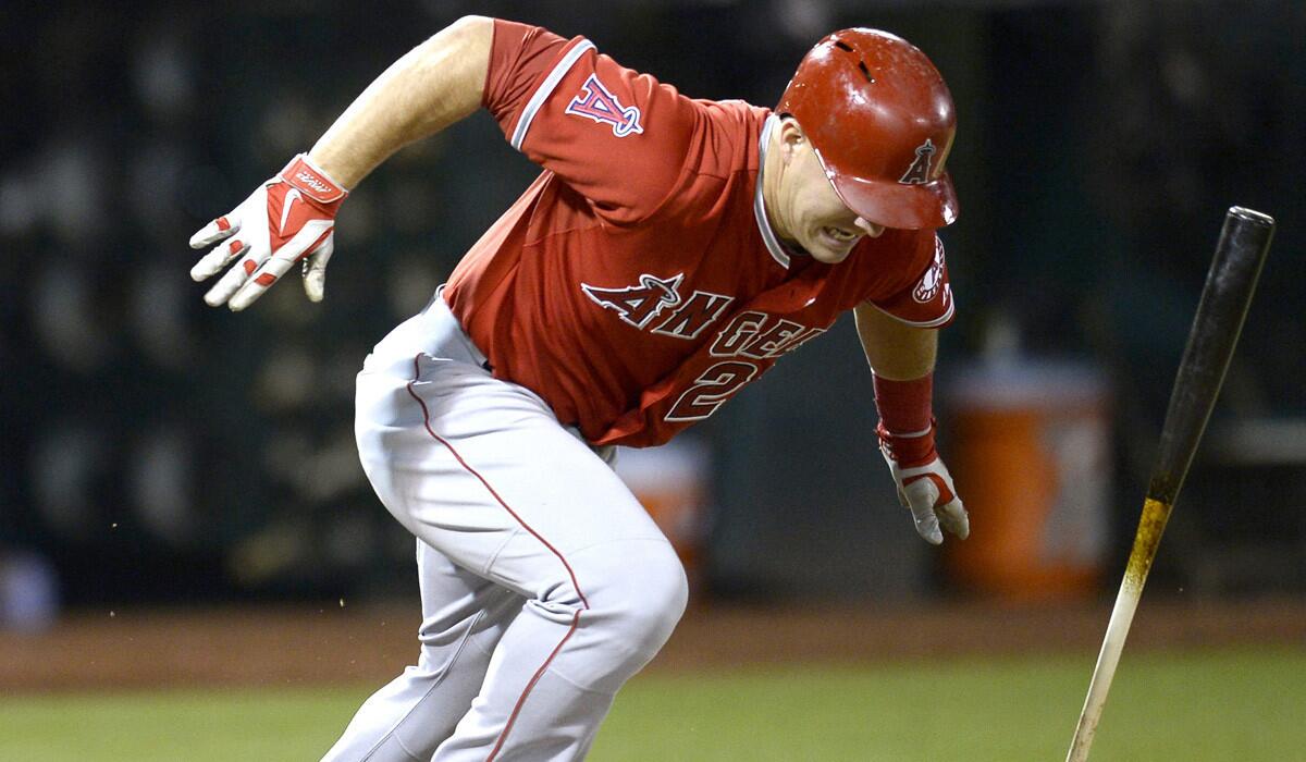 Angels center fielder Mike Trout exits the batter's box after singling against the A's in the seventh inning of their game Friday night in Oakland.