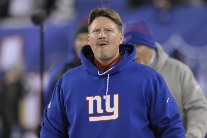 New York Giants Coach Ben McAdoo walks on the field before a game against the Dallas Cowboys on Dec. 11.