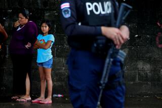 CHACARITA, PUNTARENAS - AUGUST 23: A young girls looks on while Costa Rica Police officers conduct a roadblock stopping motorist to ask them questions on Wednesday, Aug. 23, 2023 in Chacarita, Puntarenas. Costa Rica was known as a rare safe haven in an otherwise turbulent region. But lately violence has been creeping in. The country's homicide rate has been climbing for years, this year is on track to be Costa Rica's bloodiest yet. The rise in killings, which experts trace to drug trafficking, has spurred some politicians to call for more hard-line approaches to crime. (Gary Coronado / Los Angeles Times)