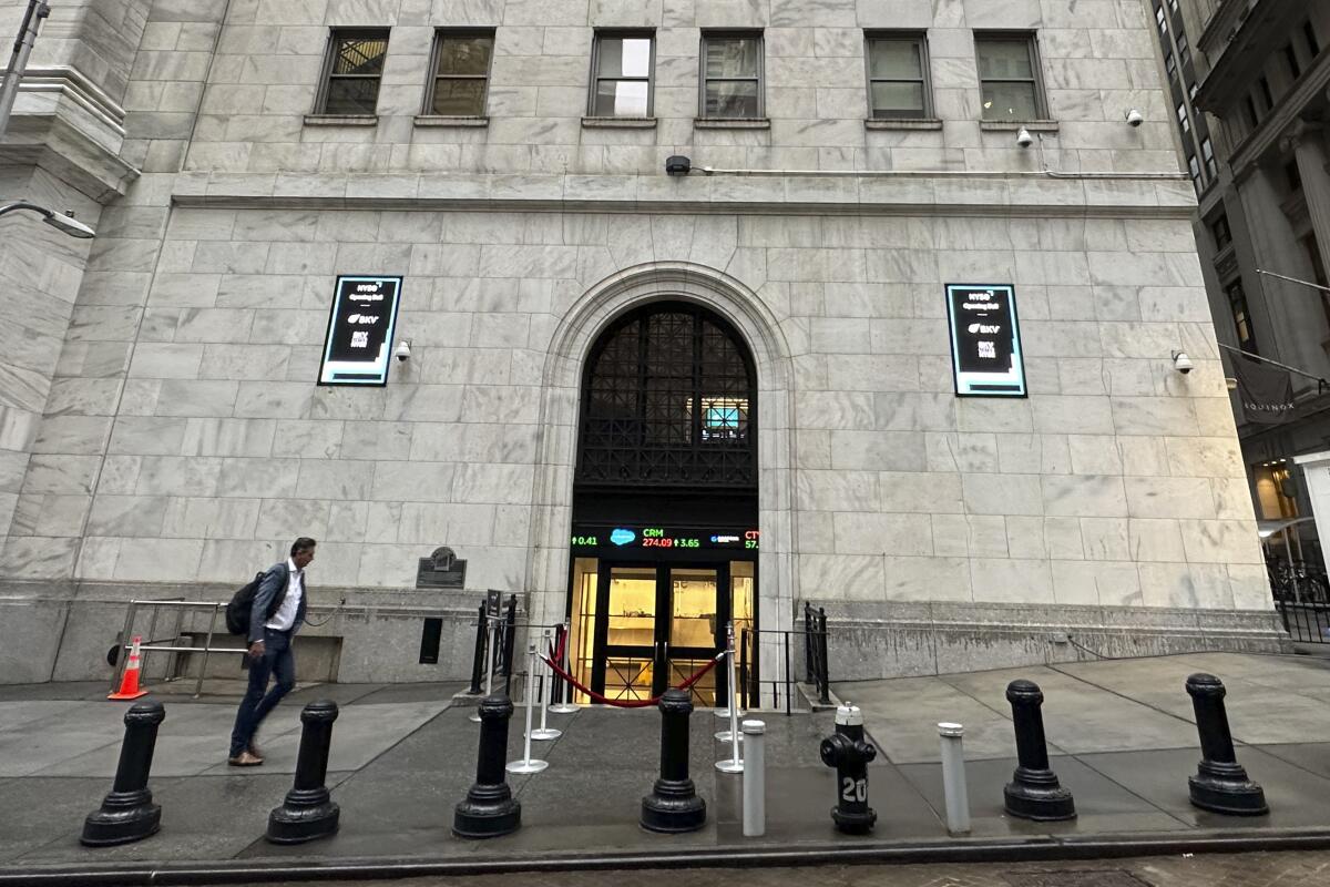 A man approaches an entrance to the New York Stock Exchange.