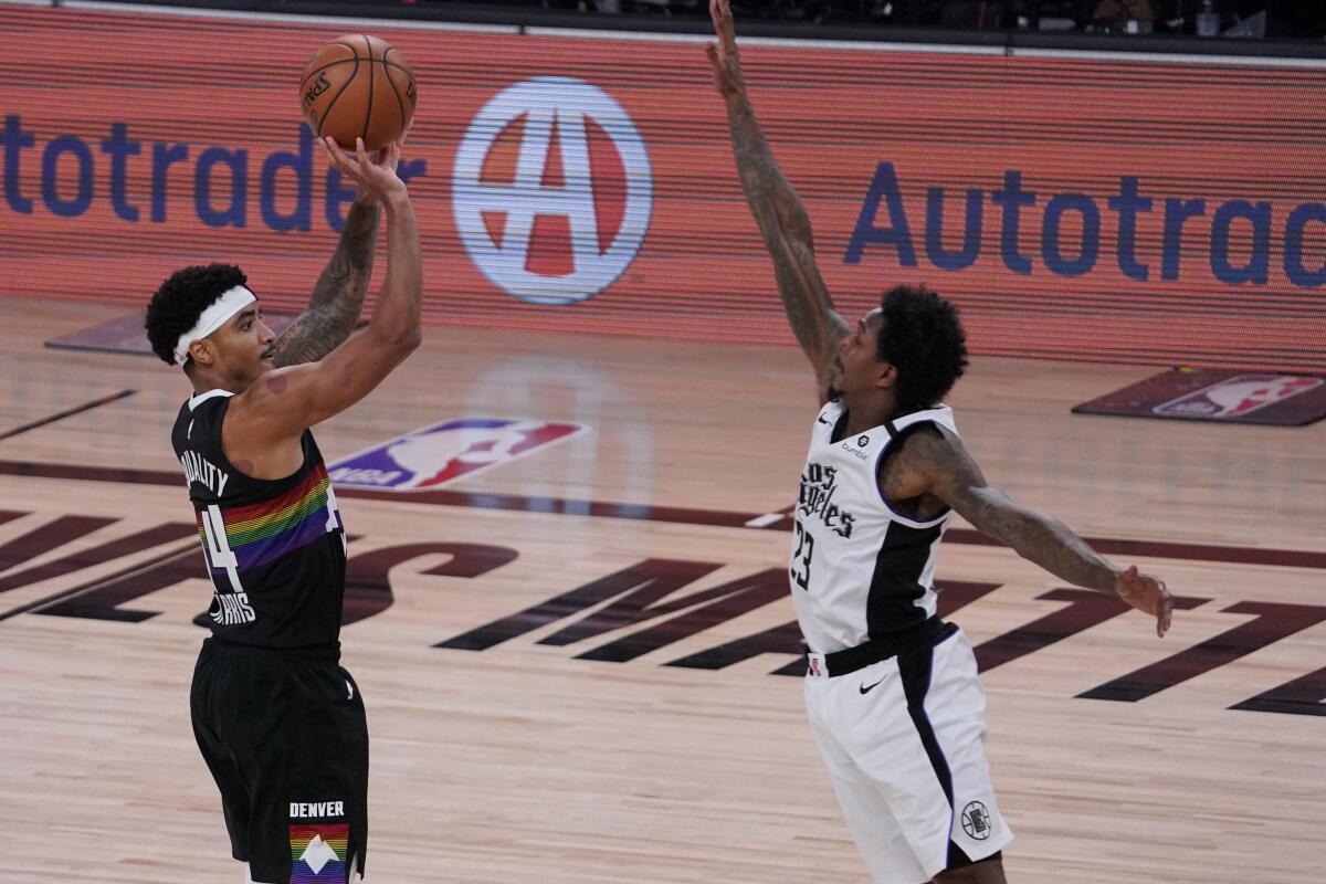 Denver Nuggets' Gary Harris takes a shot over Clippers' Lou Williams.