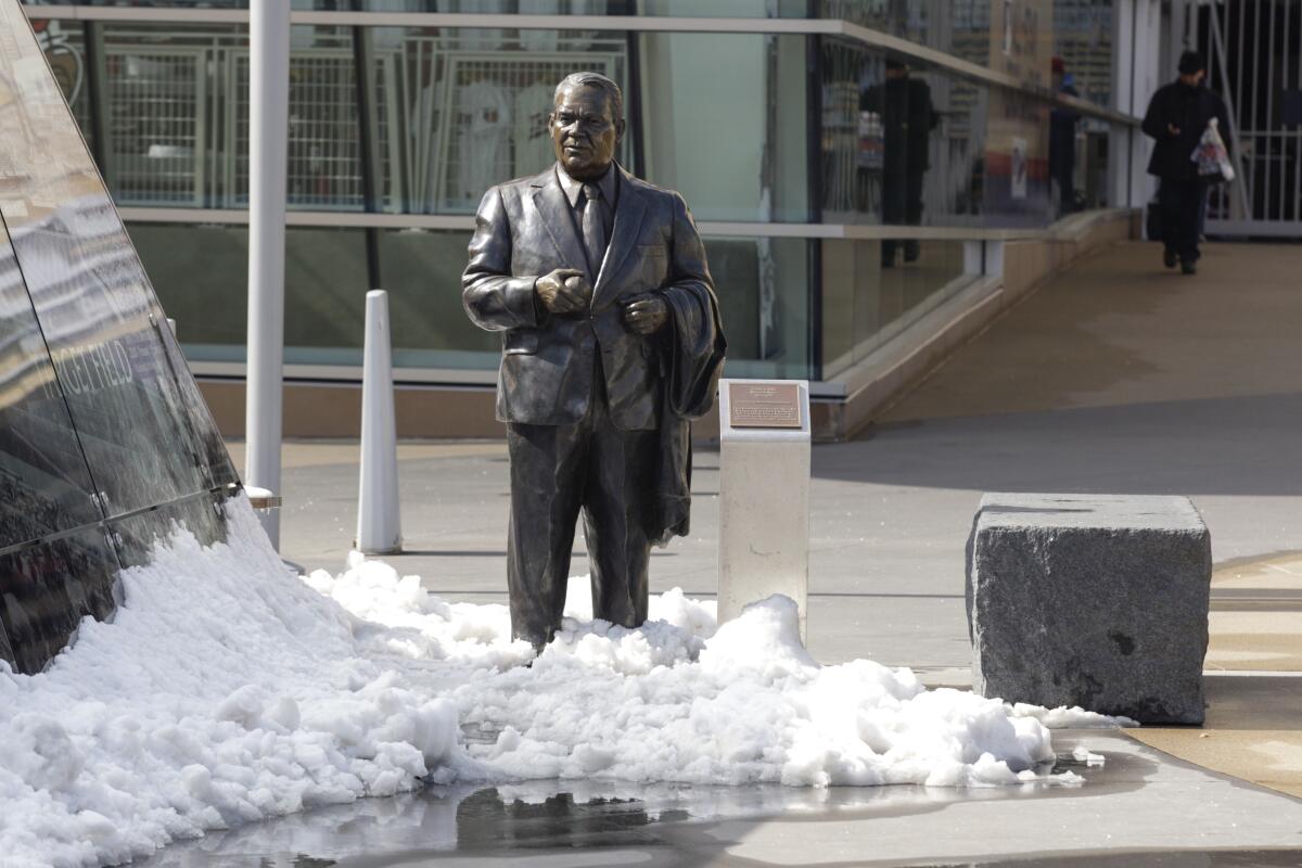 A statue of former Twins' owner Calvin Griffith stands in the snow outside Target Field.