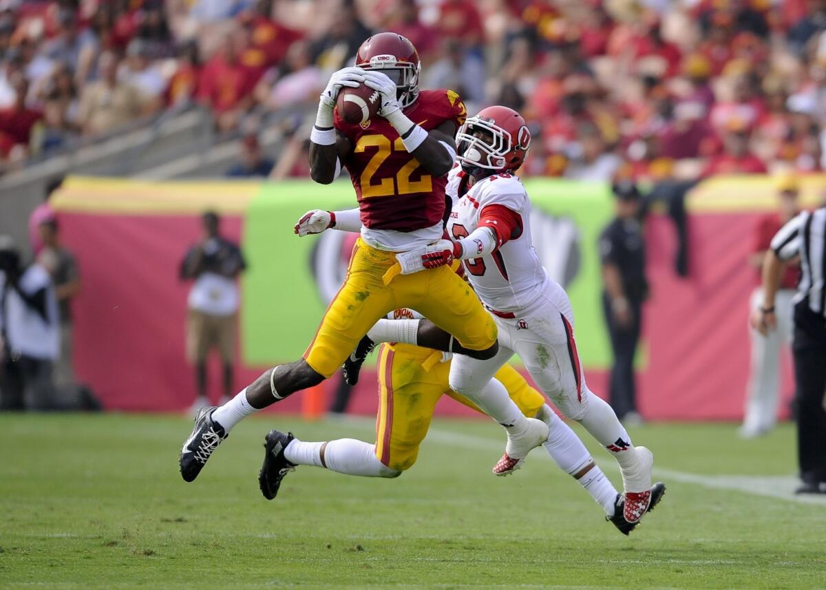 USC safety Leon McQuay III intercepts a pass intended for Utah wide receiver Geoff Norwood, right, during the Trojans' 19-3 win Saturday.