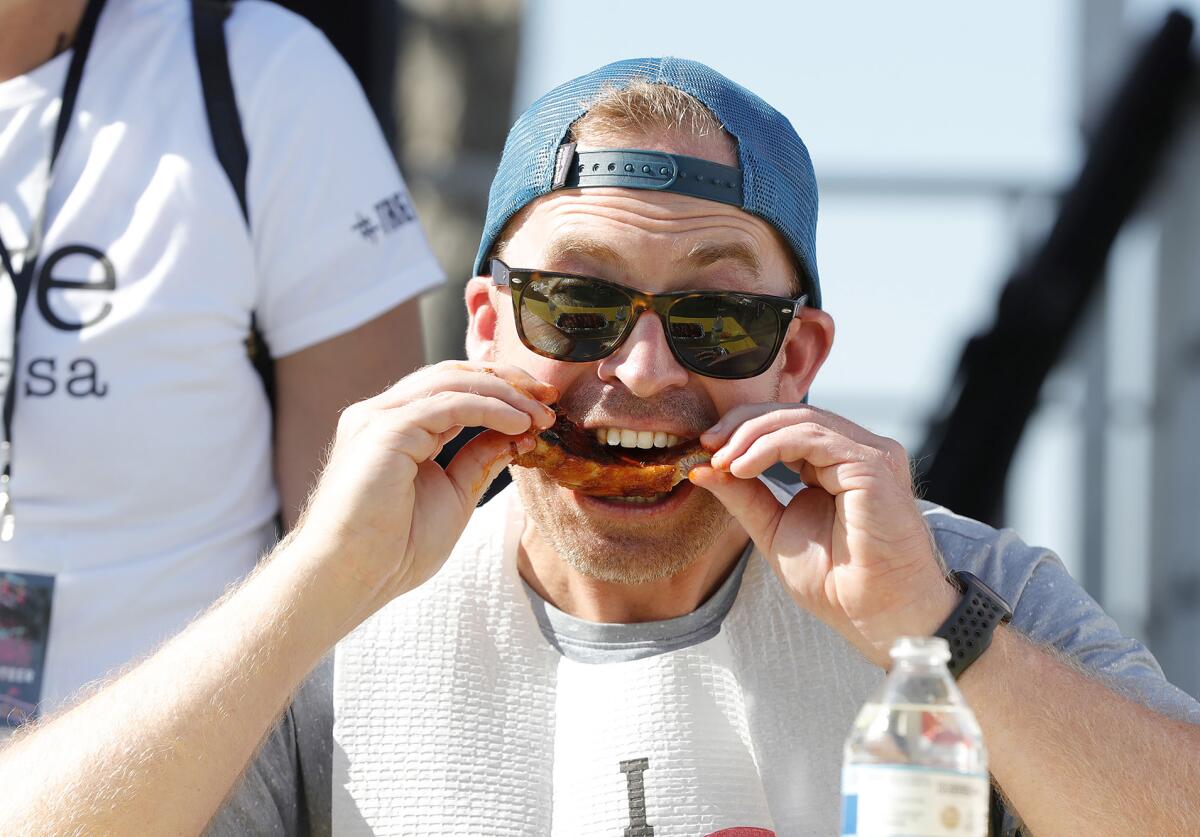 Ben Ka digs into 25 ribs at the rib eating contest during the return of Costa Mesa's "Concert in the Park." 