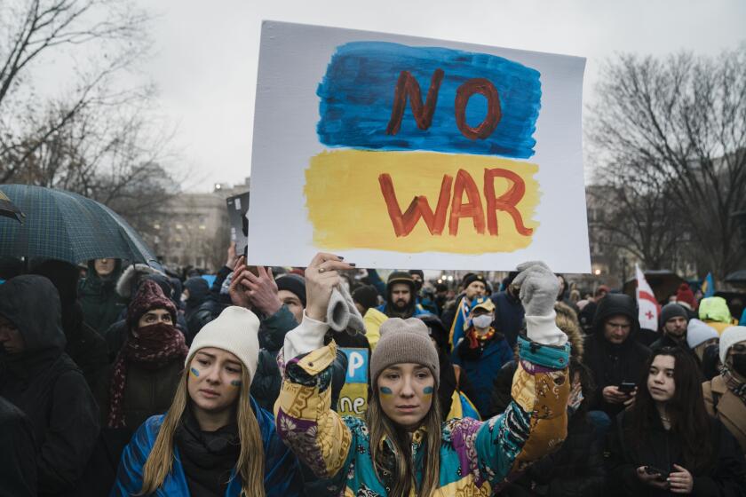WASHINGTON, DC - FEBRUARY 24: Elena Quiles and Oleksandra Yashan, both of Arlington join other demonstrators gather at the White House to protest against Russia's invasion of Ukraine on Thursday, Feb. 24, 2022 in Washington, DC. Attendees called for U.S. President Joe Biden to take a more aggressive response to Russia actions in regards to the invasion of Ukraine. (Kent Nishimura / Los Angeles Times)