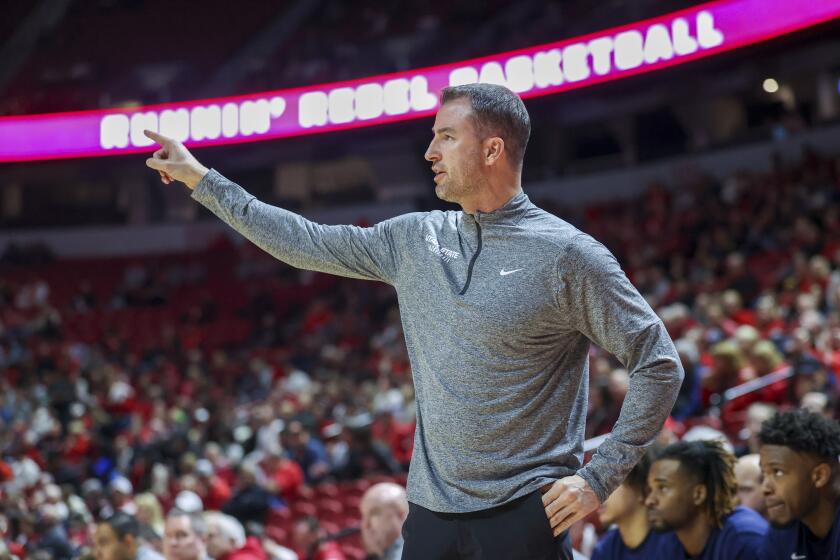 Utah State head coach Danny Sprinkle instructs his team against the UNLV during the first half of an NCAA college basketball game Saturday, Jan. 13, 2024, in Las Vegas. (AP Photo/Ian Maule)