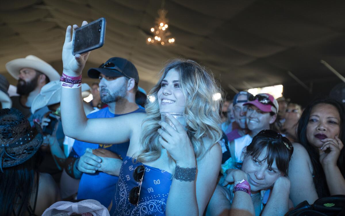 Fans enjoy Ronnie Milsap's performance on the Palomino Stage.