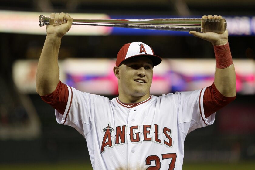 American League outfielder Mike Trout, of the Los Angeles Angels, holds the MVP trophy after his team's 5-3 victory over the National League in the MLB All-Star baseball game, Tuesday, July 15, 2014, in Minneapolis. (AP Photo/Jeff Roberson)