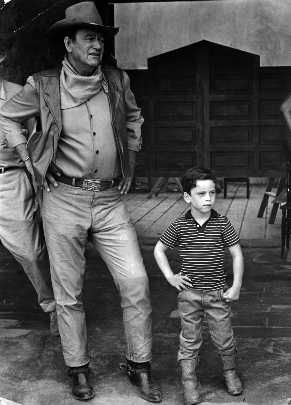 John Wayne, with his son, on location in Mexico for the filming of "The War Wagon" in 1967.