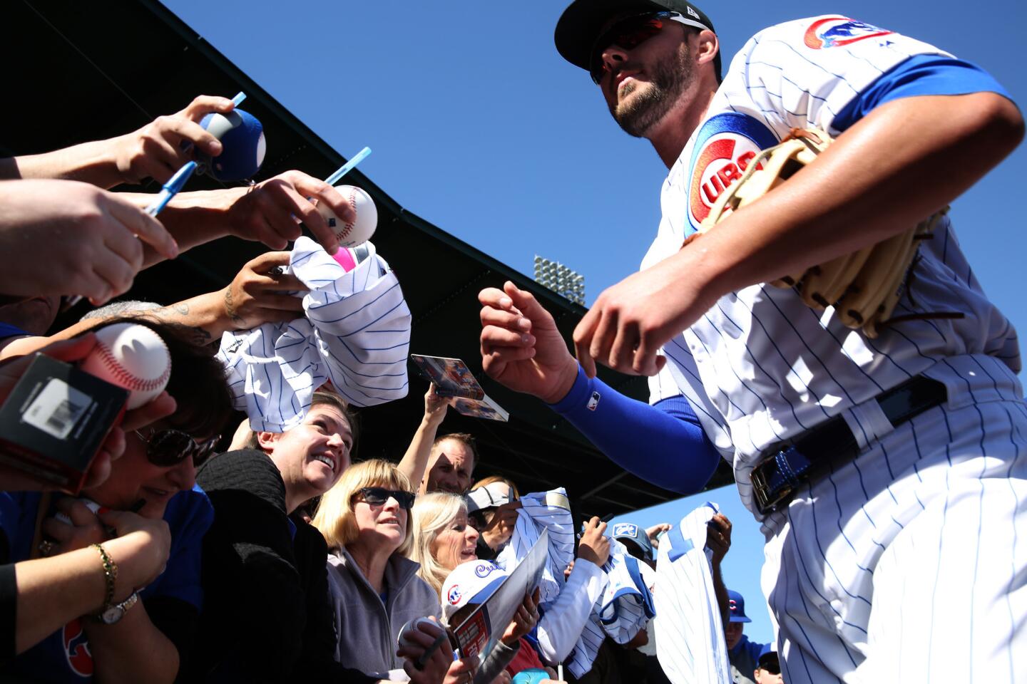 Kris Bryant signs autographs before a Cactus League game on Saturday, Feb. 24, 2018.