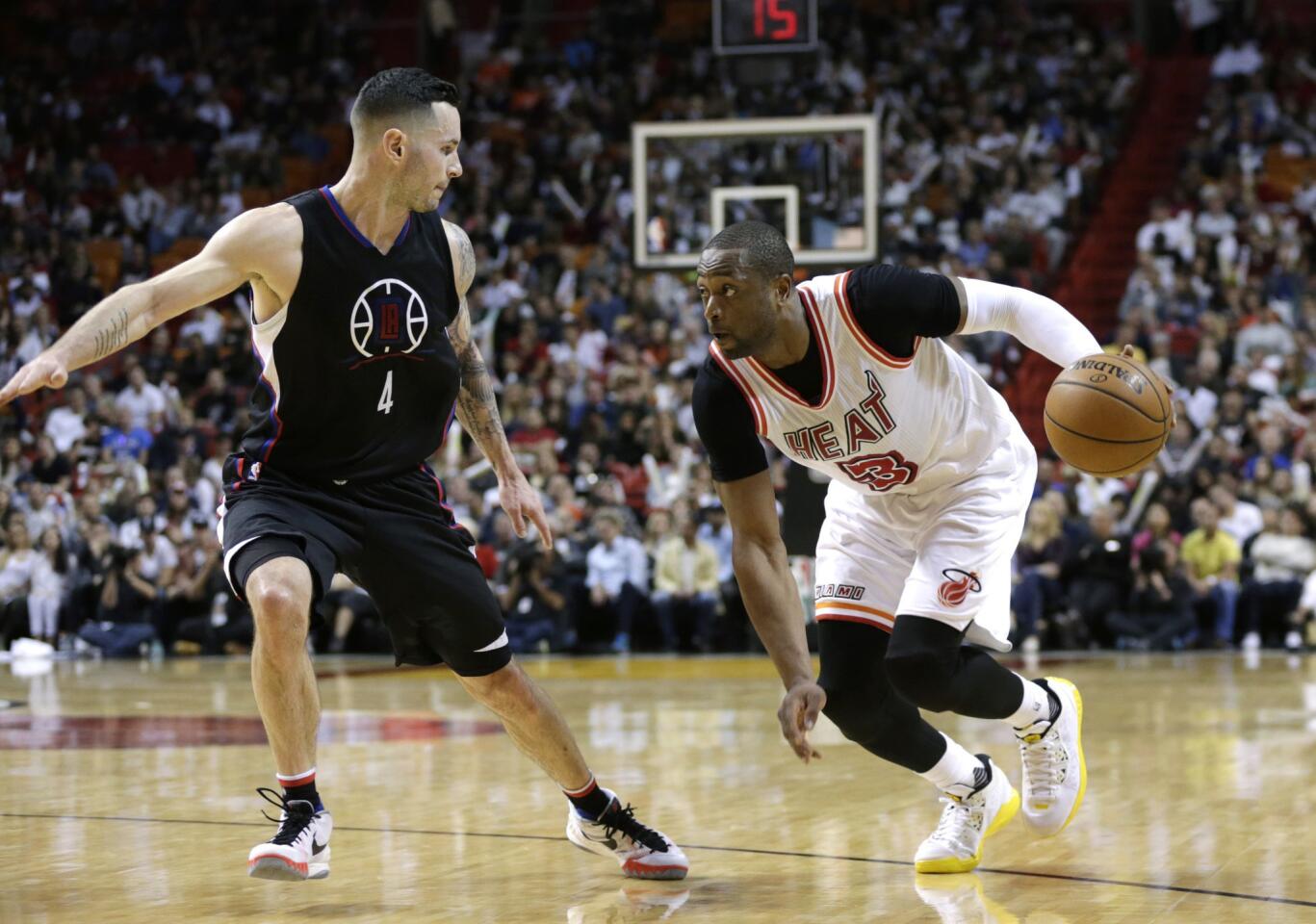 Heat guard Dwyane Wade (3) drives to the basket against Clippers guard J.J. Redick (4) during the second half.