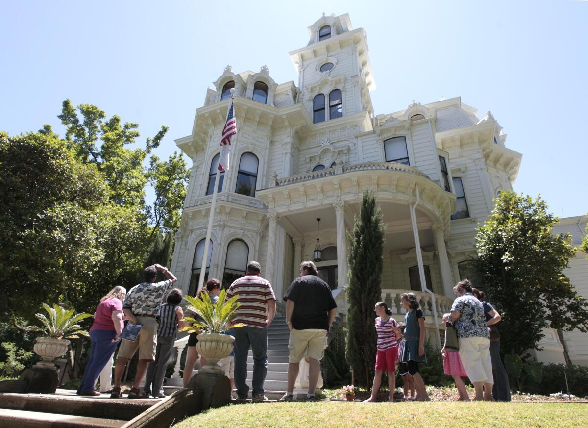 A tour group pauses outside the Victorian-style governor's mansion in Sacramento.