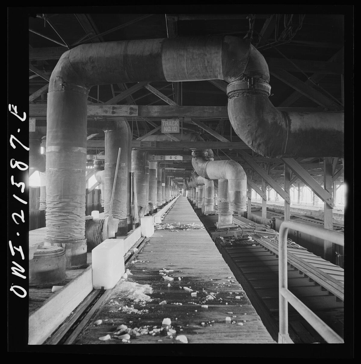 Railroad refrigerator cars, lower right, are precooled at a San Bernardino ice plant prior to loading with perishable goods grown in Southern California. Twenty-degree air is blown through the cars before they are packed with ice and the goods to be shipped.