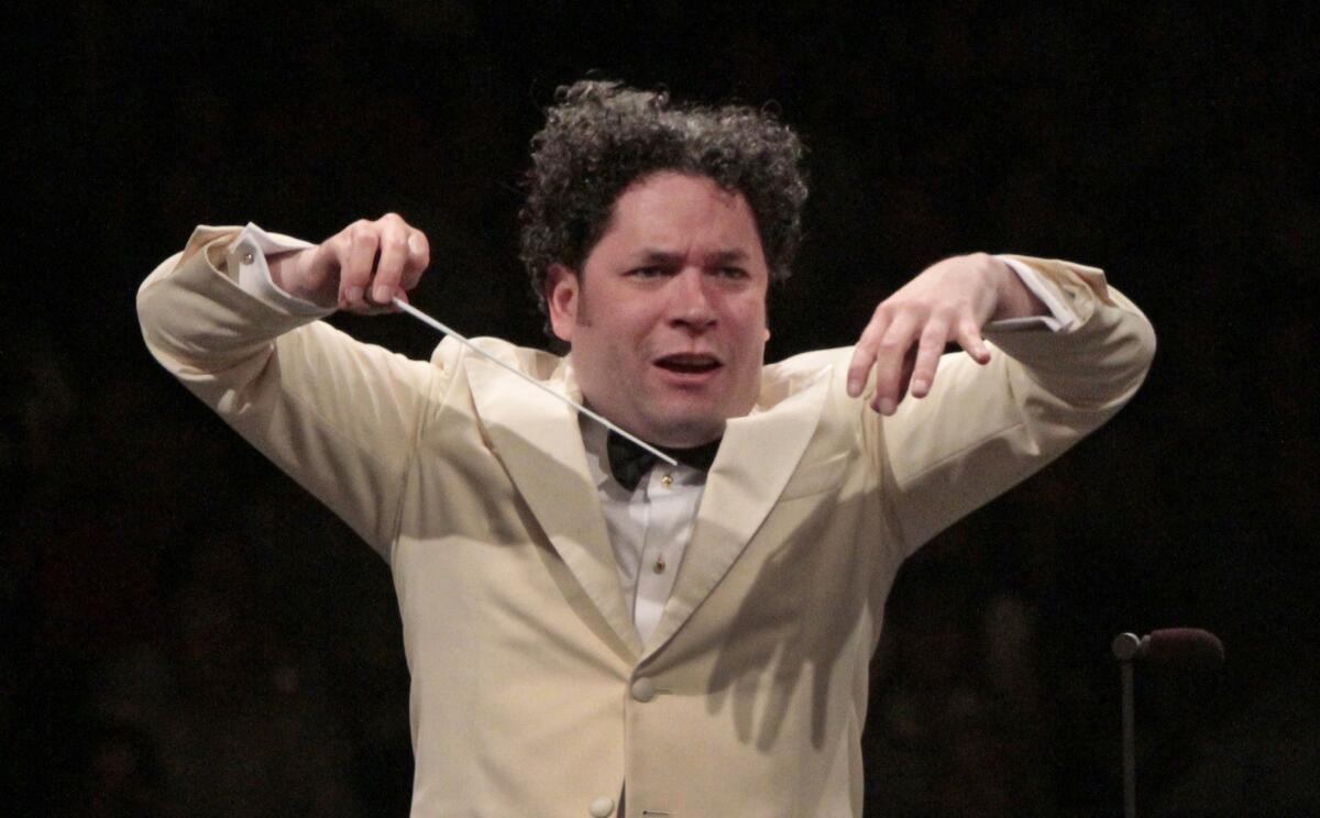 Gustavo Dudamel is shown conducting the Los Angeles Philharmonic at the Hollywood Bowl in July.