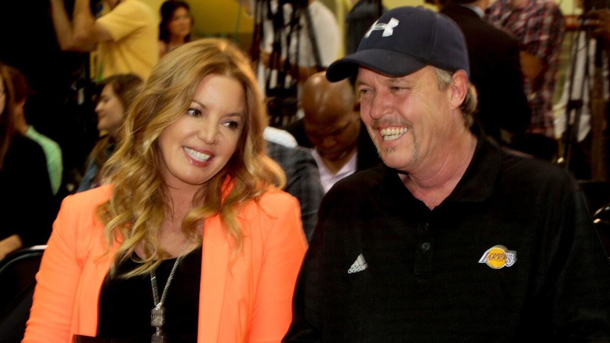 Jeanie and Jim Buss chat before the start of a news conference to introduce Dwight Howard as the Lakers' new center on Aug. 10, 2012.