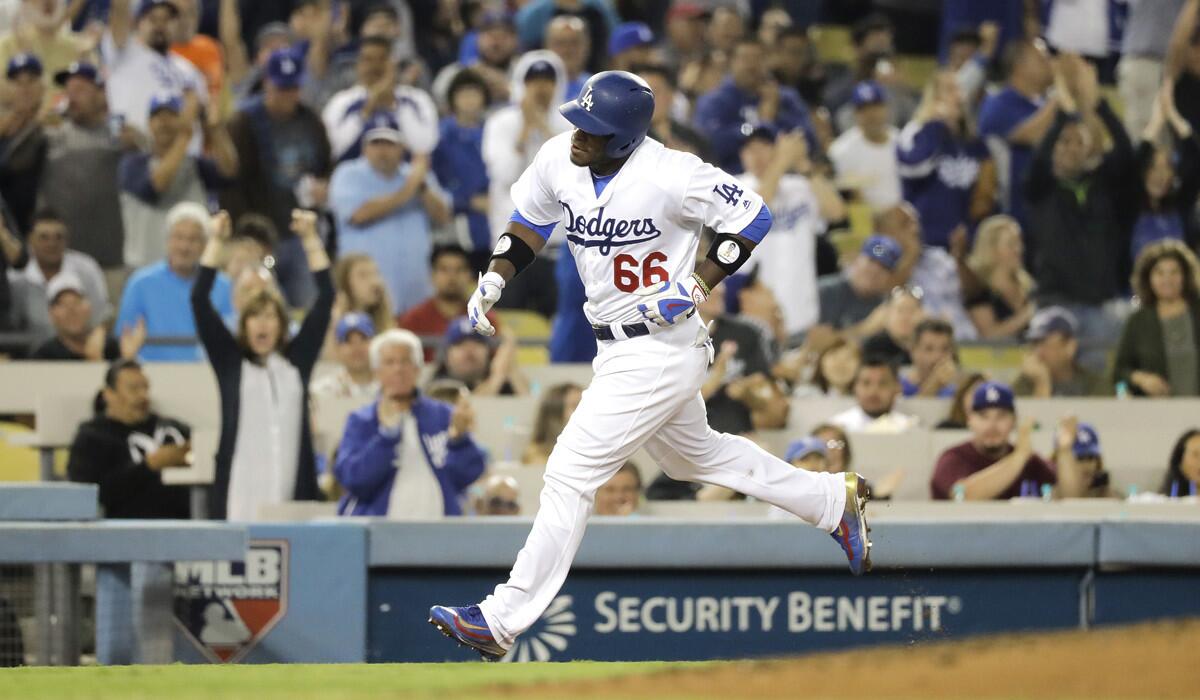 Dodgers' Yasiel Puig rounds the bases after hitting a home run during the sixth inning against the Arizona Diamondbacks on Wednesday at Dodger Stadium.