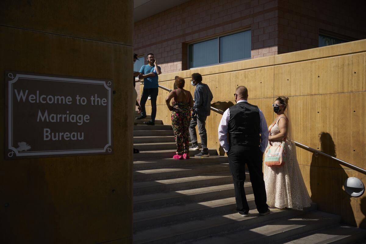Couples wait in line for marriage licenses at the Marriage License Bureau, Friday, April 2, 2021, in Las Vegas. The bureau was seeing busier than normal traffic ahead of 4/3/21, a popular day to get married in Las Vegas. (AP Photo/John Locher)