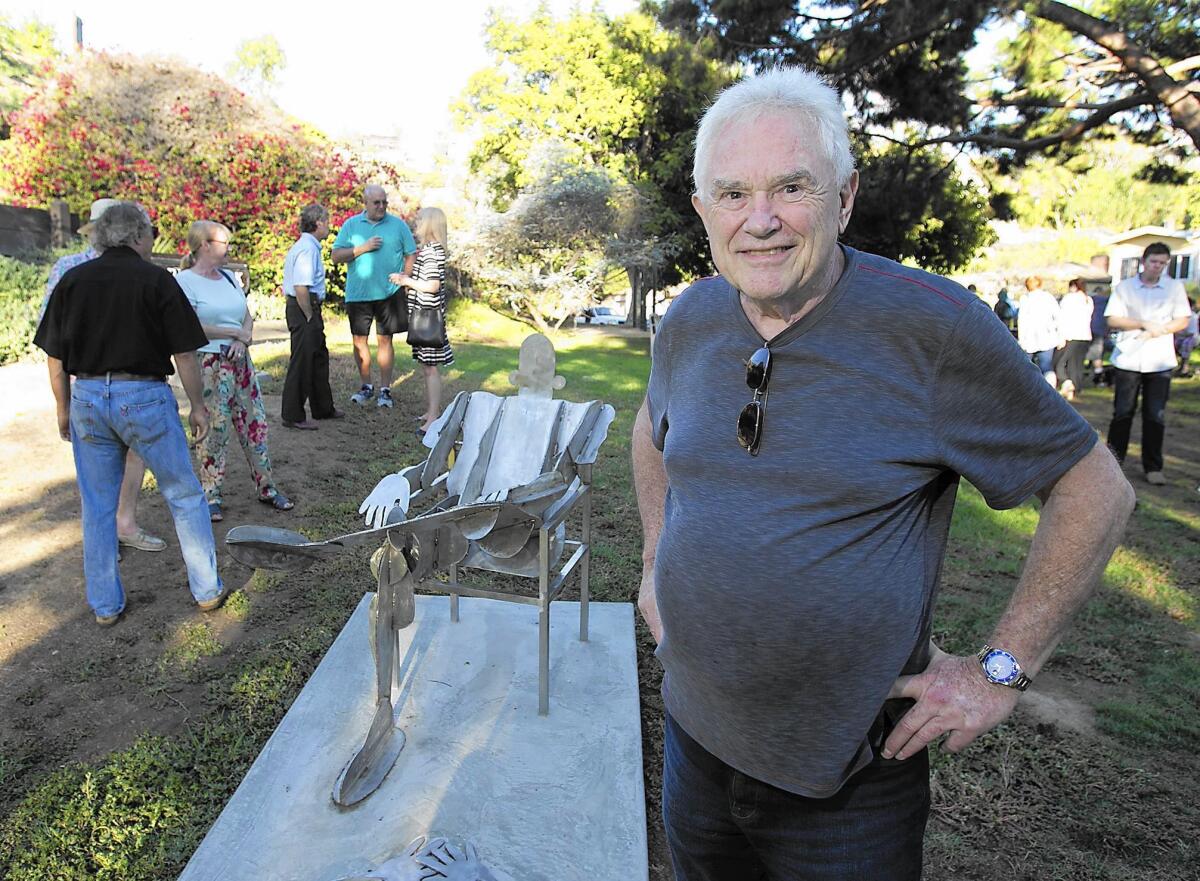 Artist Leonard Glasser stands in front of the new “Sunbathers” public art sculpture during a commemoration ceremony at Rita Carman Park in Laguna Beach.