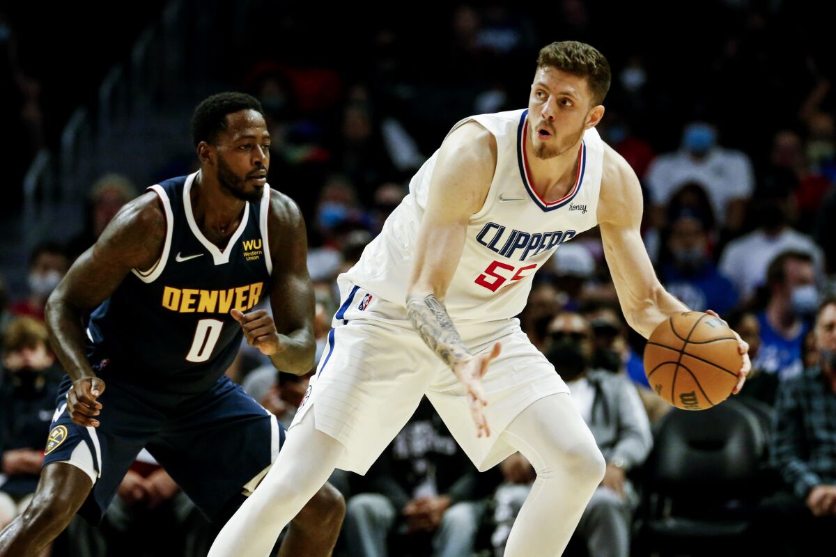 Clippers center Isaiah Hartenstein is defended by Nuggets forward JaMychal Green.