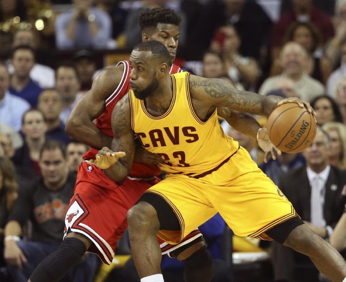 Cleveland's LeBron James is defended by Chicago's Jimmy Butler during the first half of Game 5 of the Eastern Conference playoff series between the Cavaliers and the Bulls.