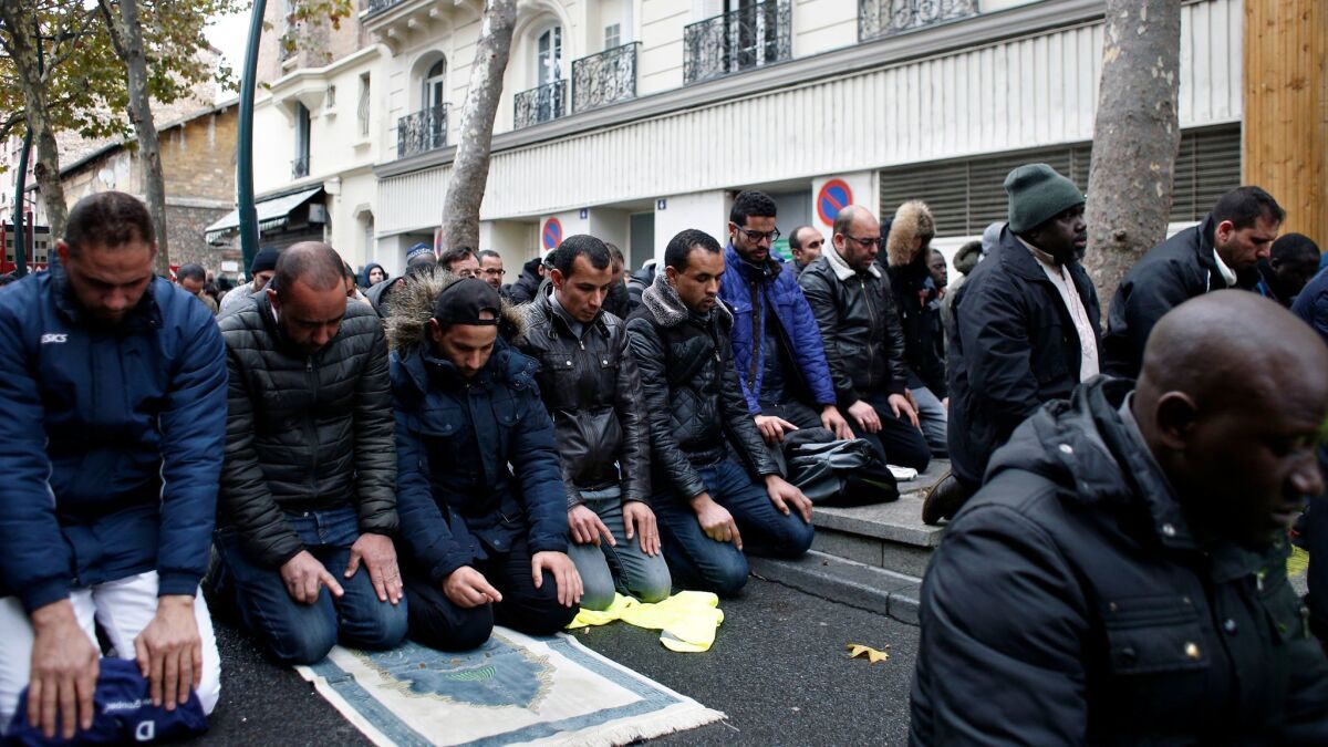 Muslims hold Friday prayers in the street Nov. 10 in the Paris suburb of Clichy la Garenne.