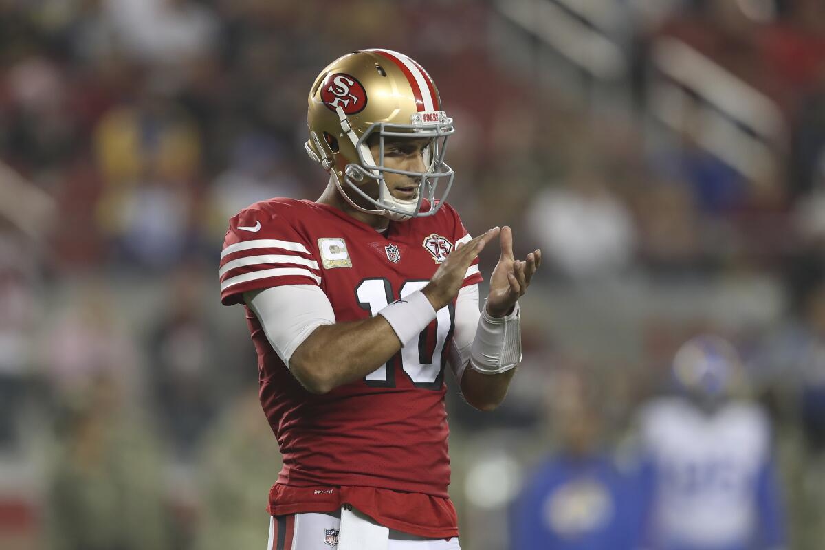 San Francisco 49ers quarterback Jimmy Garoppolo (10) signals teammates during a Monday night game against the Rams.