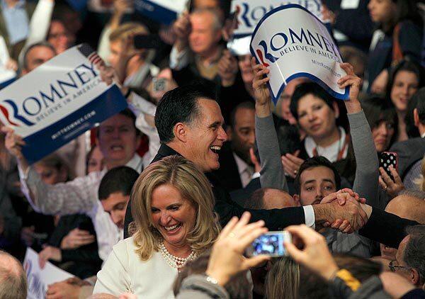 Former Massachusetts Gov. Mitt Romney and his wife, Ann, greet supporters at a victory party at Southern New Hampshire University in Manchester, N.H.