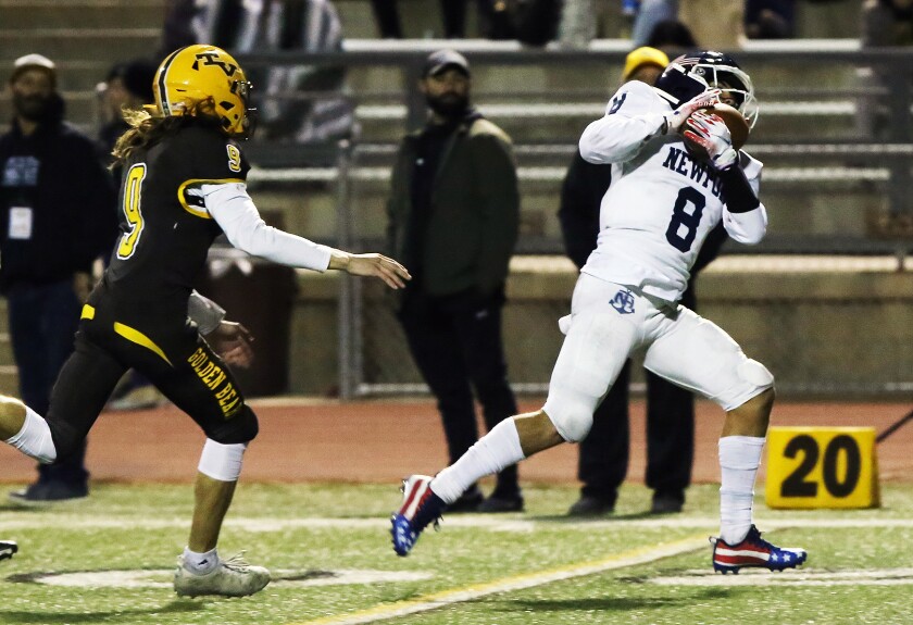 Newport Harbor's Josiah Lamarque (8) catches a pass for his second touchdown of the game.
