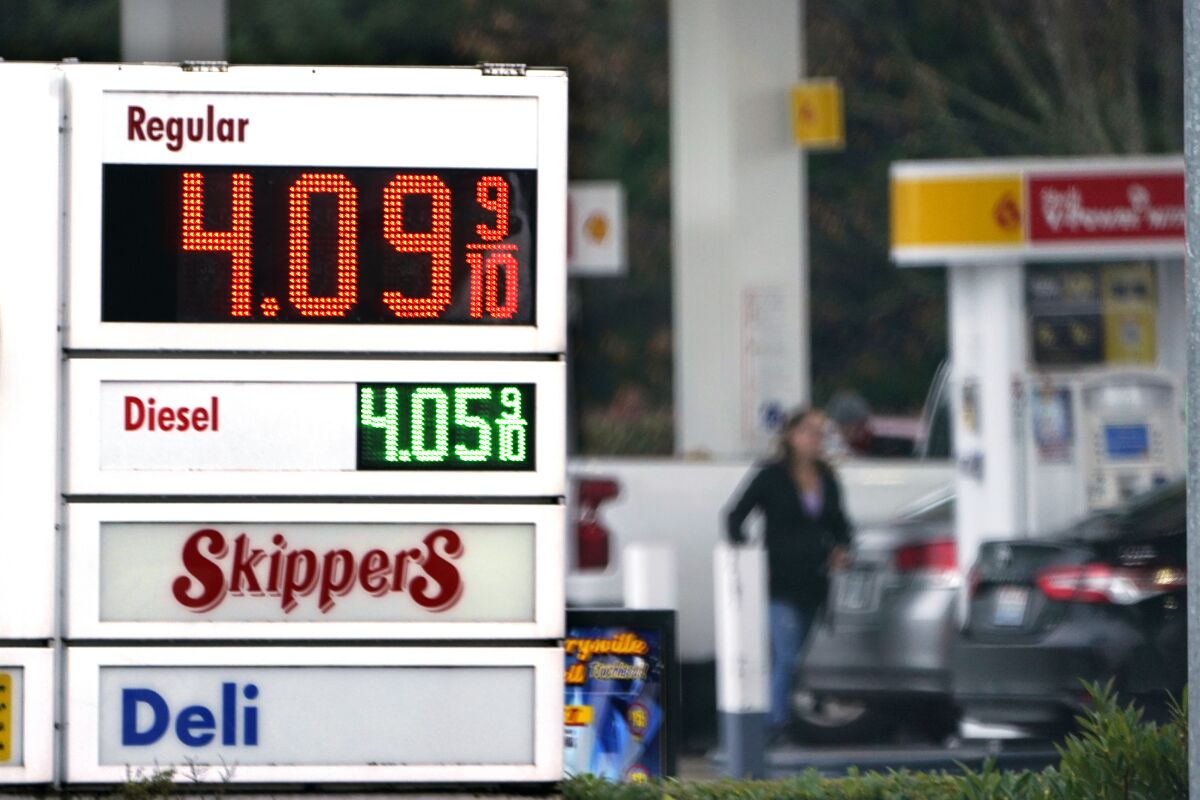FILE - A driver fills a tank at a gas station Friday, Dec. 10, 2021, in Marysville, Wash. Consumer prices rose 6.8% for the 12 months ending in November, a 39-year high. Many economists expect inflation to remain near this level a few more months but to then moderate through 2022 for a variety of reasons. And they don't see a repeat of the 1970s or early 1980s, when inflation ran above 10% for frighteningly long stretches. (AP Photo/Elaine Thompson, File)