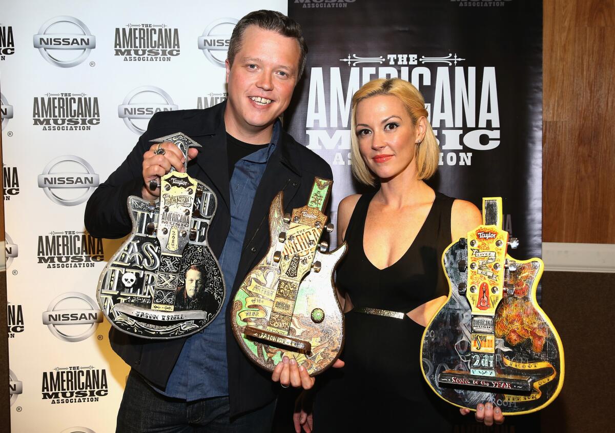 Jason Isbell and wife Amanda Shires pose for photos at the Americana Music Awards at Ryman Auditorium in Nashville on Sept. 17.