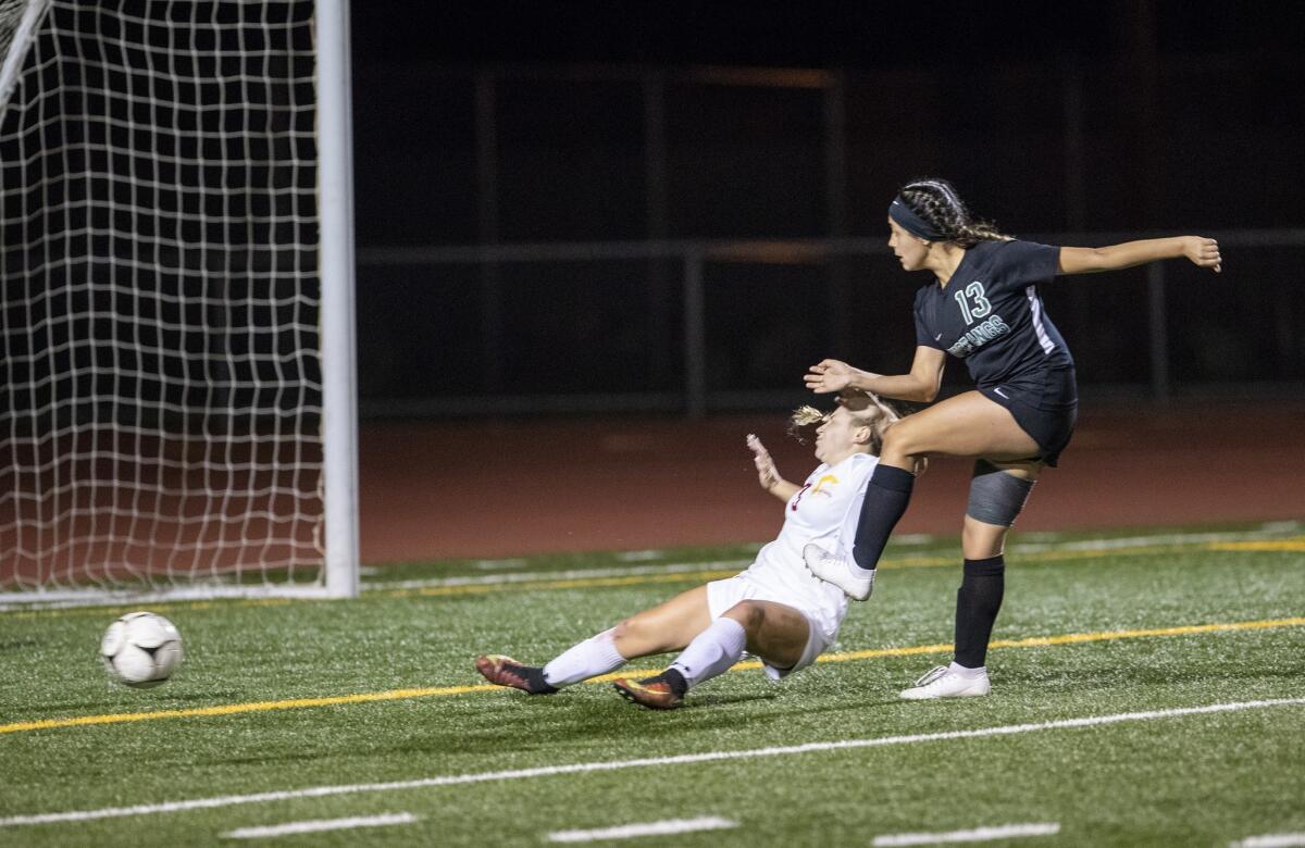Costa Mesa High's Natalia Guzman (13) scores the game winner on Hillcrest defender Kaila Smith during stoppage time in the quarterfinals of the CIF Southern Section Division 5 playoffs on Tuesday.