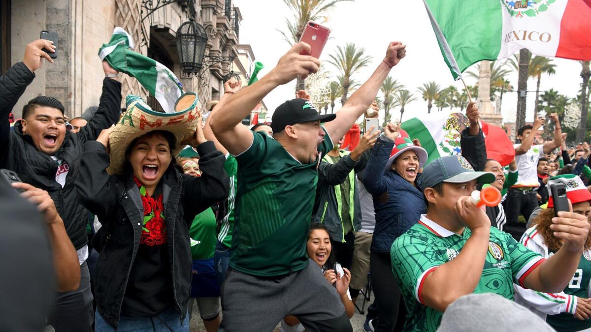 Fans celebrate Mexico's first goal while watching the World Cup match between Mexico and South Korea at Plaza Mexico in Lynwood.