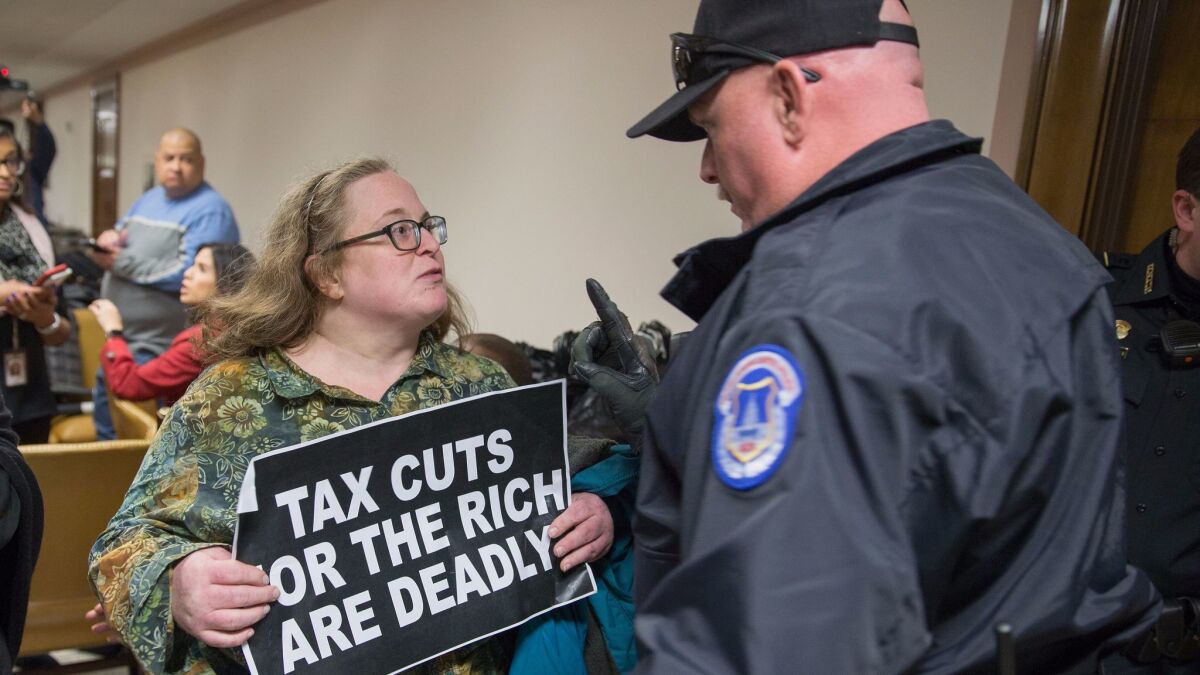 Protesters demonstrate near the full Senate Budget Committee markup of the tax reform legislation on Capitol Hill on Nov. 28.