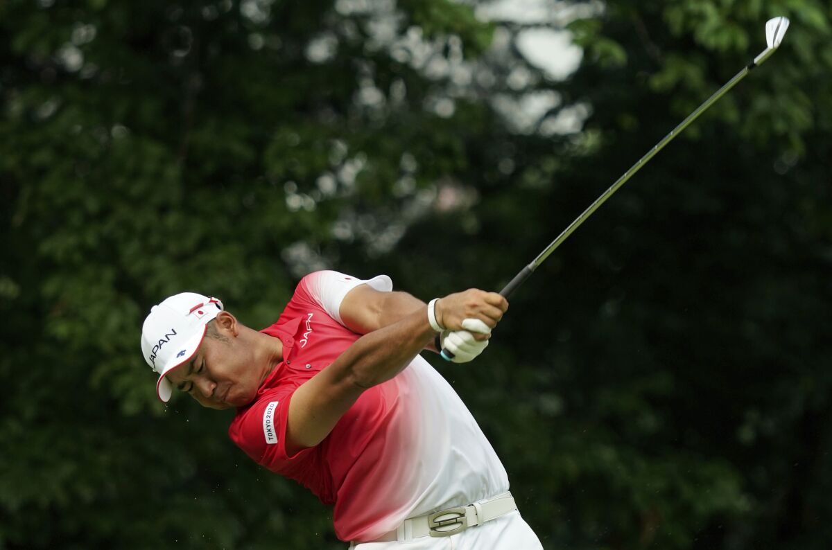 Hideki Matsuyama swings a golf club at the Tokyo Olympics.