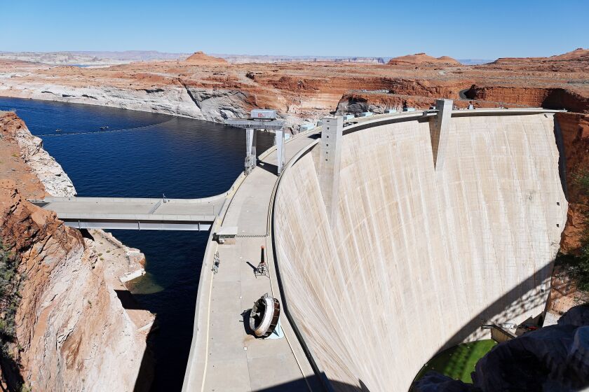 PAGE, AZ - OCTOBER 14: The Glen Canyon Dam sits above Lake Powell and the Colorado River on October 14, 2022 in Page, Arizona. The water in Lake Powell and the Colorado River has been receding due to recent droughts leaving parts of the lake and river parched. The federal government are moving forward with plans to reduce water allocations from the Colorado River Basin to Arizona and is asking millions of residents to reduce their water consumption as the drought get worse. (Photo by Joshua Lott/The Washington Post via Getty Images)