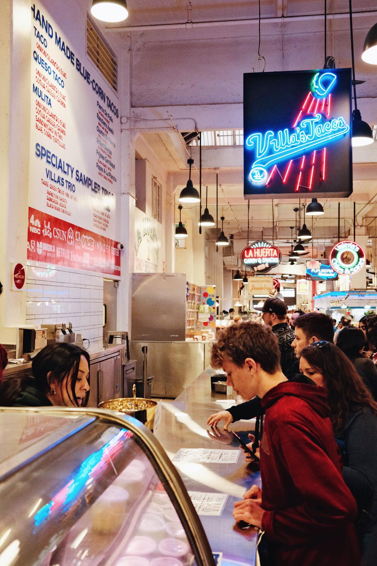 Guests ordering at the Villa's Tacos stand in Grand Central Market Los Angeles