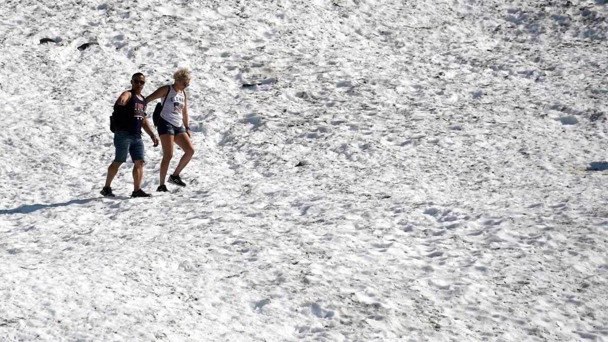 People hike on Byron Glacier in Girdwood, Alaska. Anchorage hit the 90-degree mark on Thursday, breaking a record of 85 degrees set half a century ago.