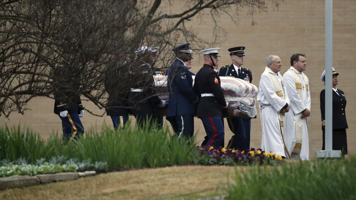 The flag-draped coffin of former President George H.W. Bush is carried by a military honor guard at the George H.W. Bush Presidential Library and Museum in College Station, Texas.