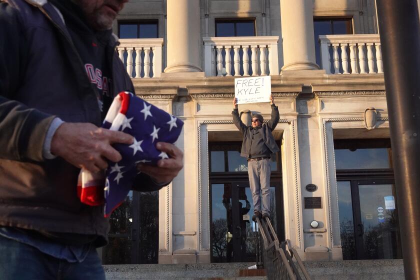KENOSHA, WISCONSIN - NOVEMBER 19: Brandon Lesco, a supporter of Kyle Rittenhouse, holds a sign that says "Free Kyle" outside of the Kenosha County Courthouse hours after learning that Rittenhouse was acquitted of all charges on November 19, 2021 in Kenosha, Wisconsin. Rittenhouse, a teenager, faced homicide charges and other offenses in the fatal shootings of Joseph Rosenbaum and Anthony Huber and for shooting and wounding of Gaige Grosskreutz during unrest in Kenosha that followed the police shooting of Jacob Blake in August 2020. (Photo by Scott Olson/Getty Images)