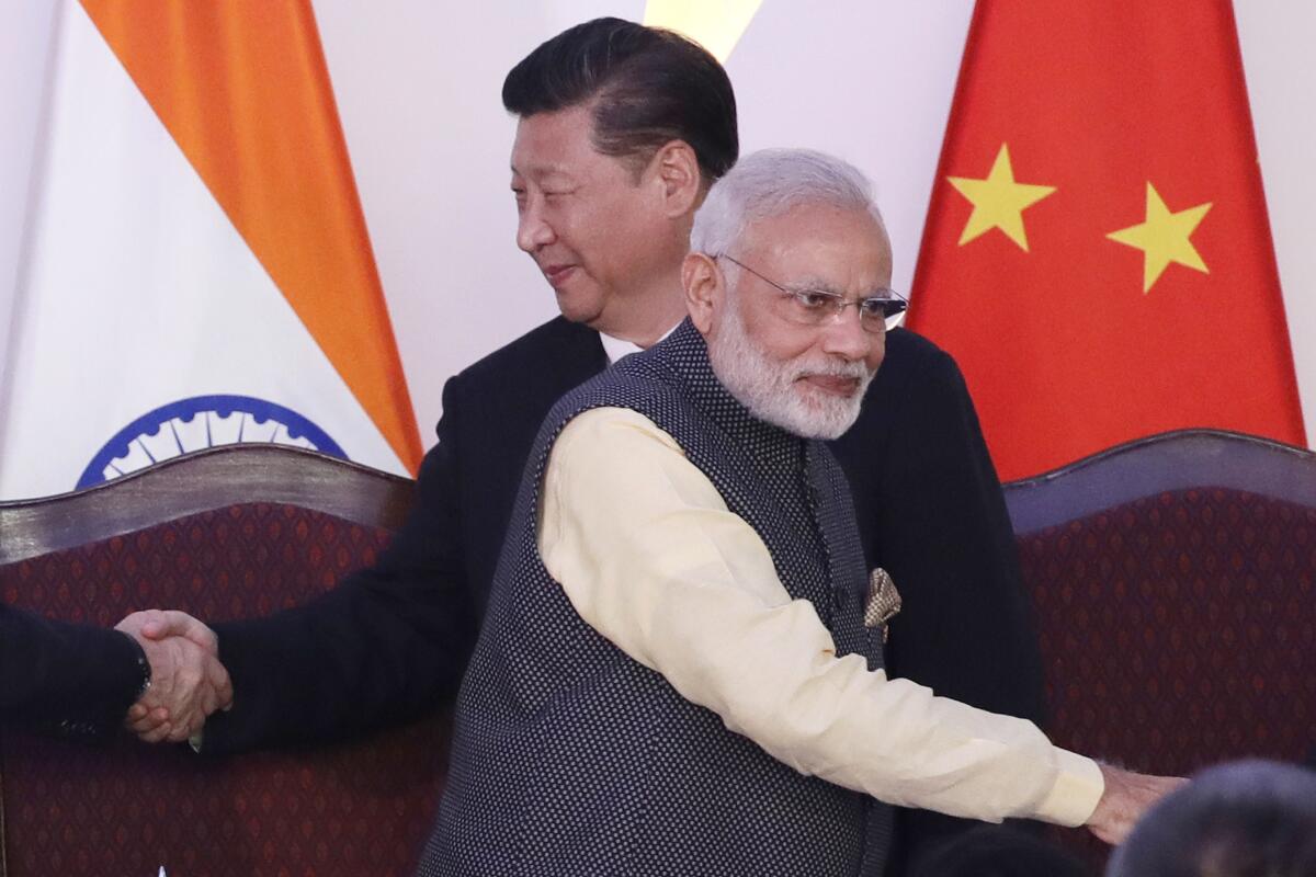 FILE- Indian Prime Minister Narendra Modi, front and Chinese President Xi Jinping shake hands with leaders at the BRICS summit in Goa, India, Oct. 16, 2016. India on Friday, Aug. 12, 2022, criticized China's decision to block the imposition of U.N. sanctions sought by it and the United States against the deputy chief of Jaish-e-Mohammad, a Pakistan-based extremist group designated by the United Nations as a terrorist organization. (AP Photo/Manish Swarup, File)